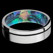 7 mm wide/Flat/14K White Gold band with one 0.5 mm Off Center inlay of Black also featuring a Abalone sleeve.