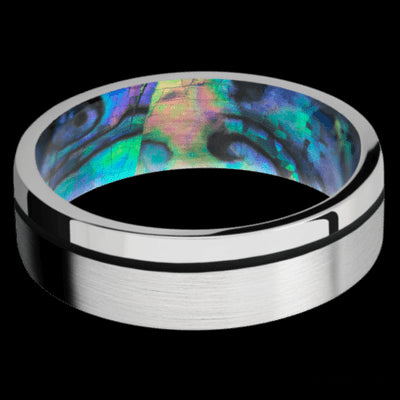 7 mm wide/Flat/14K White Gold band with one 0.5 mm Off Center inlay of Black also featuring a Abalone sleeve.